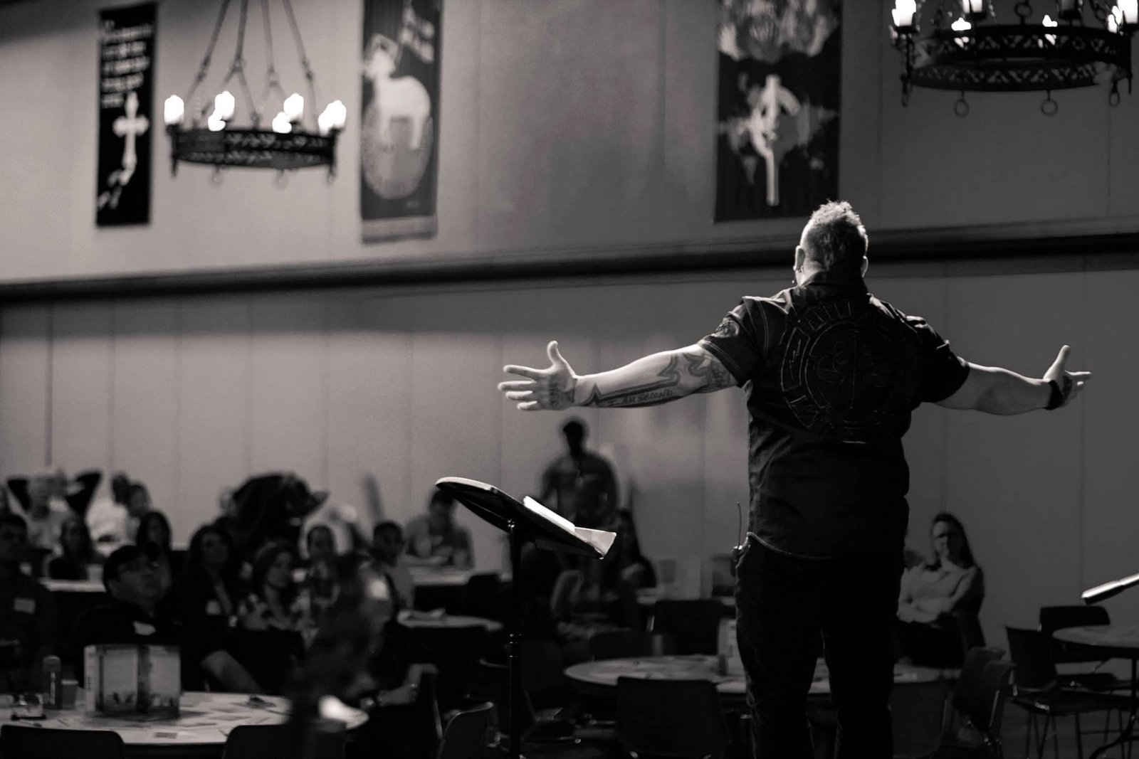 Duché Bradley with arms outstretched on stage