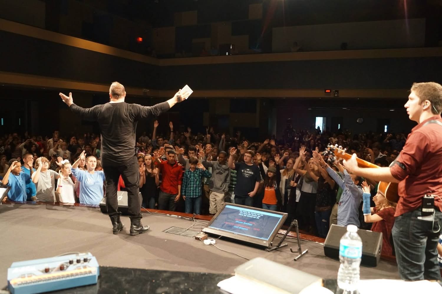 Duché Bradley speaking to a full auditorium