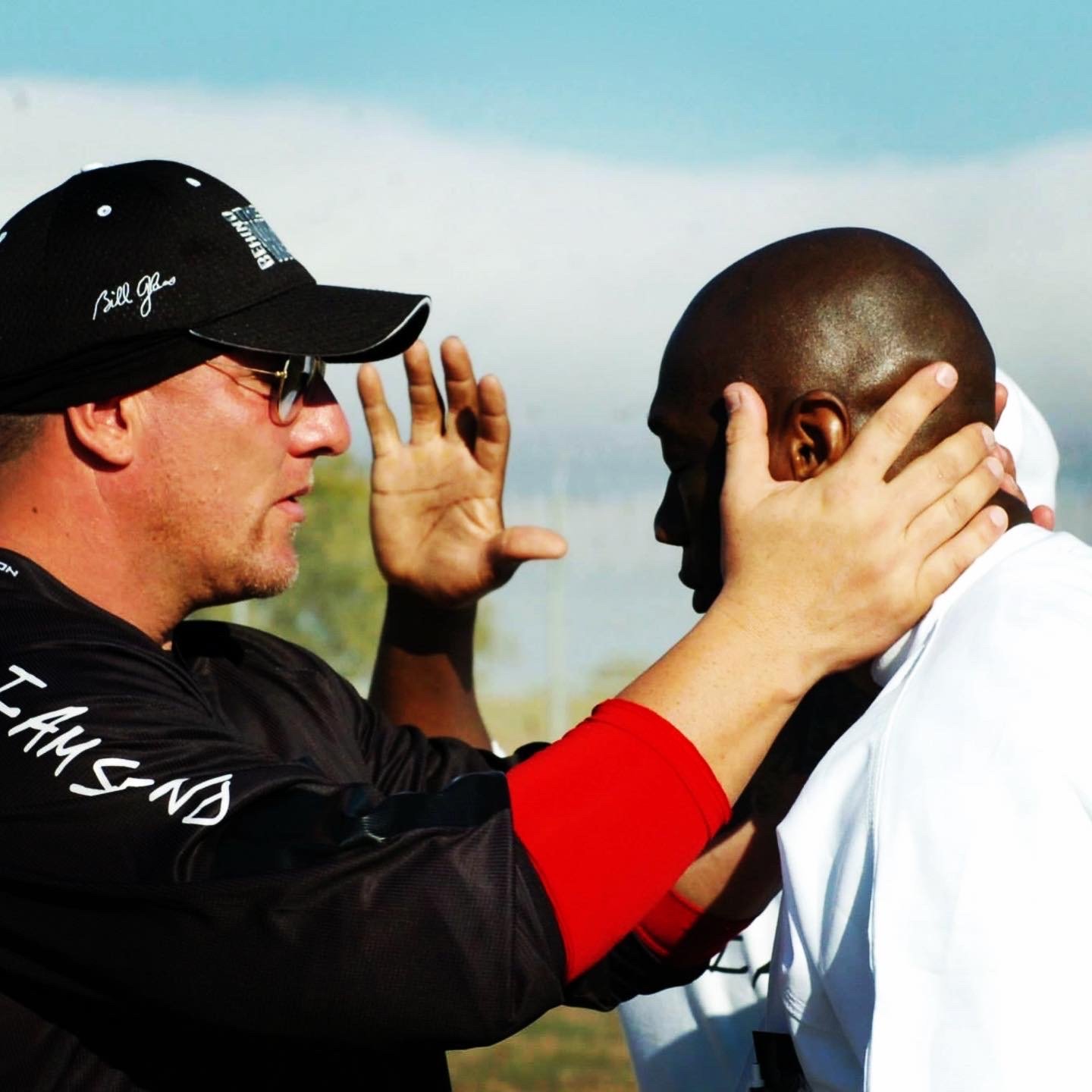 Duché Bradley praying with a man at a prison event