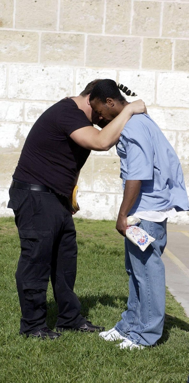 Duché Bradley embracing a man at a prison yard event
